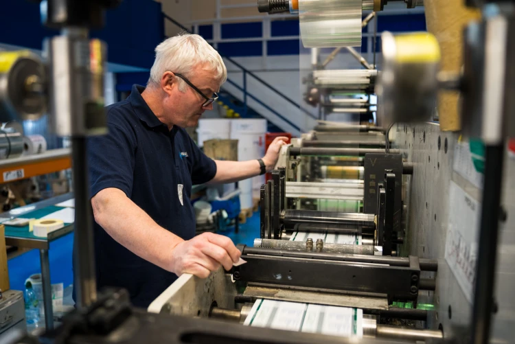 A man operating a printer 