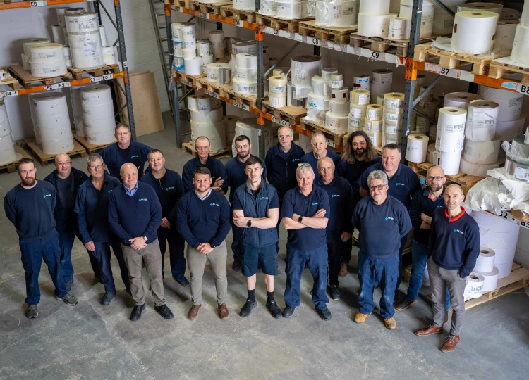 An image of the production staff standing in the Reel Label Solutions warehouse